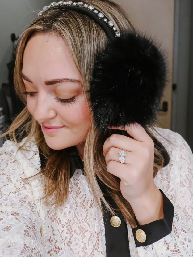 Chicago bride-to-be Jessica Sturdy wearing a pair of Hill House furry jewel-encrusted earmuffs with her Toi et Moi engagement ring.